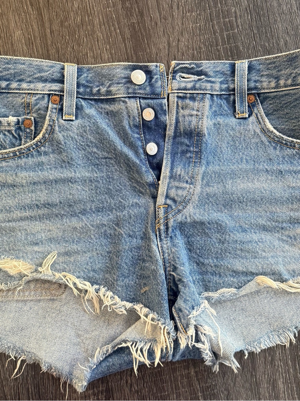 Levi's 501 Light Blue Distressed Denim Cutoff Shorts.